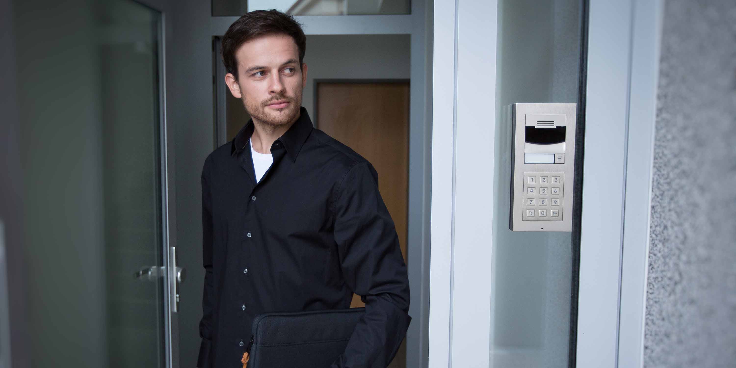 Control4 Touch panel in a able with a traditional home in the background