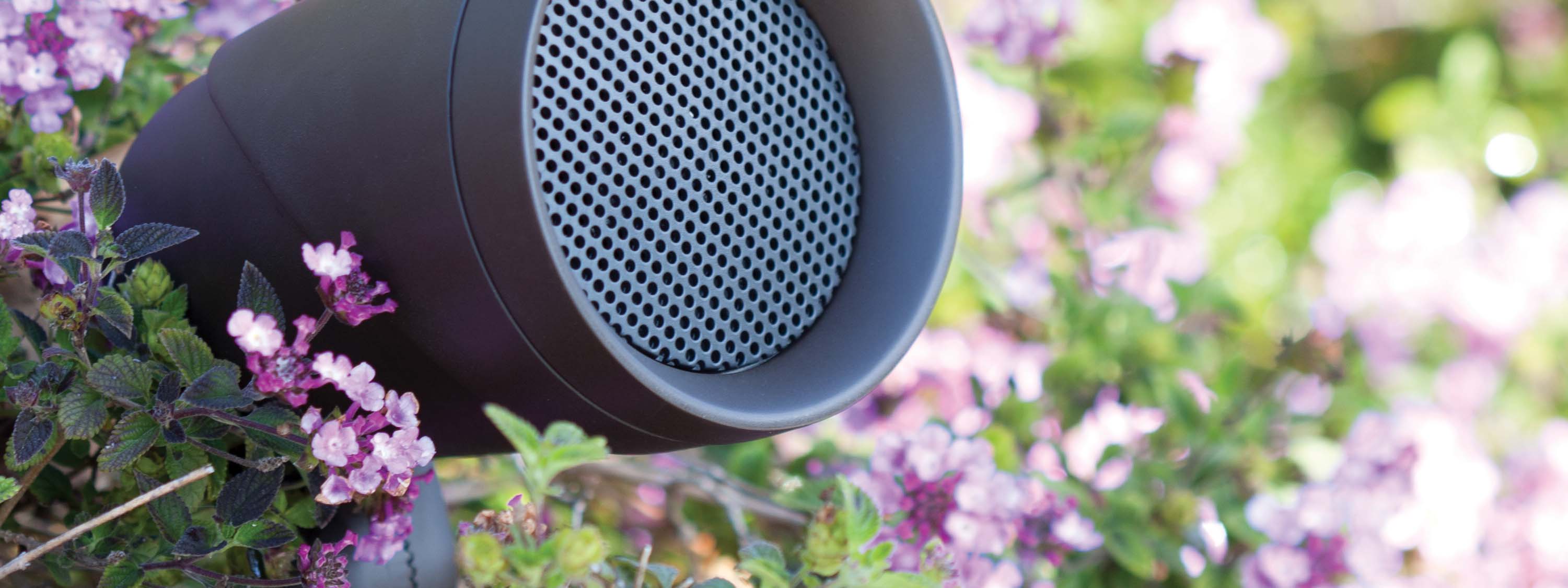 Control4 Touch panel in a able with a traditional home in the background